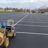 Freshly painted lines in an empty parking lot with a line marking machine.