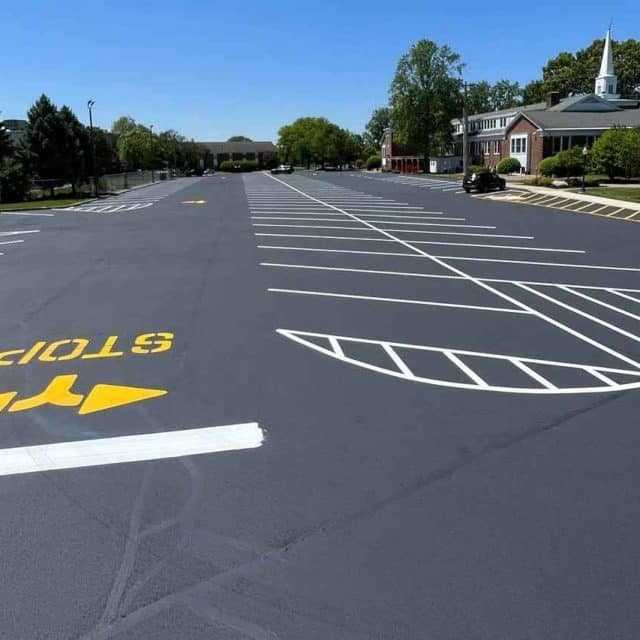 Empty parking lot with fresh lines and a church in the background.