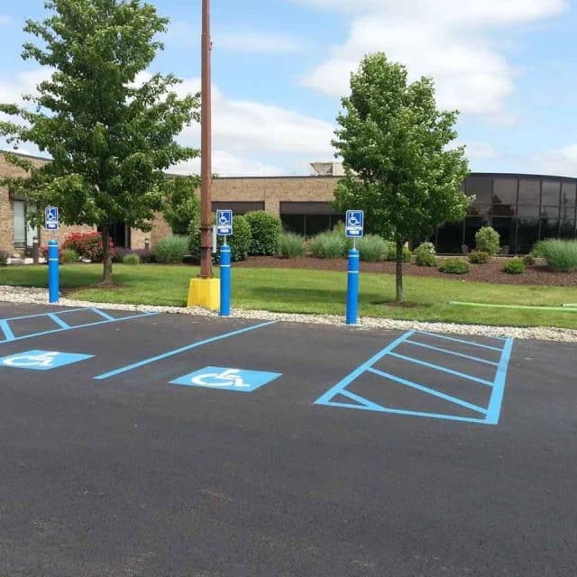 Row of empty accessible parking spaces with blue markings.