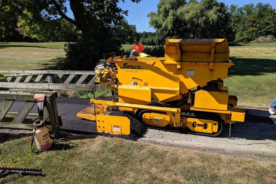 Salsco asphalt paving machine on a sunny park path.